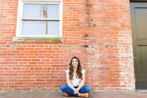Samantha-Newton-Online therapist for high functioning anxiety sitting by wall in Virginia Beach, Virginia 