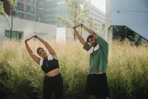 woman and man stretching their arms together to decrease anxiety in Virginia 