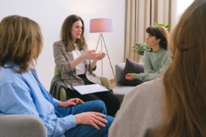 mental health therapist speaking to group of clients about anxiety 