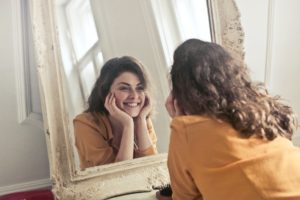 photo of woman looking at the mirror deciding on goals for anxiety therapy session