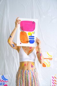 photo of woman holding paint work after therapy session for anxiety in North Carolina 